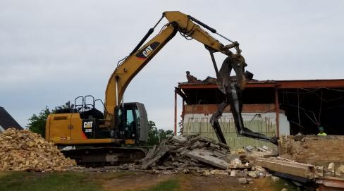 old school being demolished using a crane